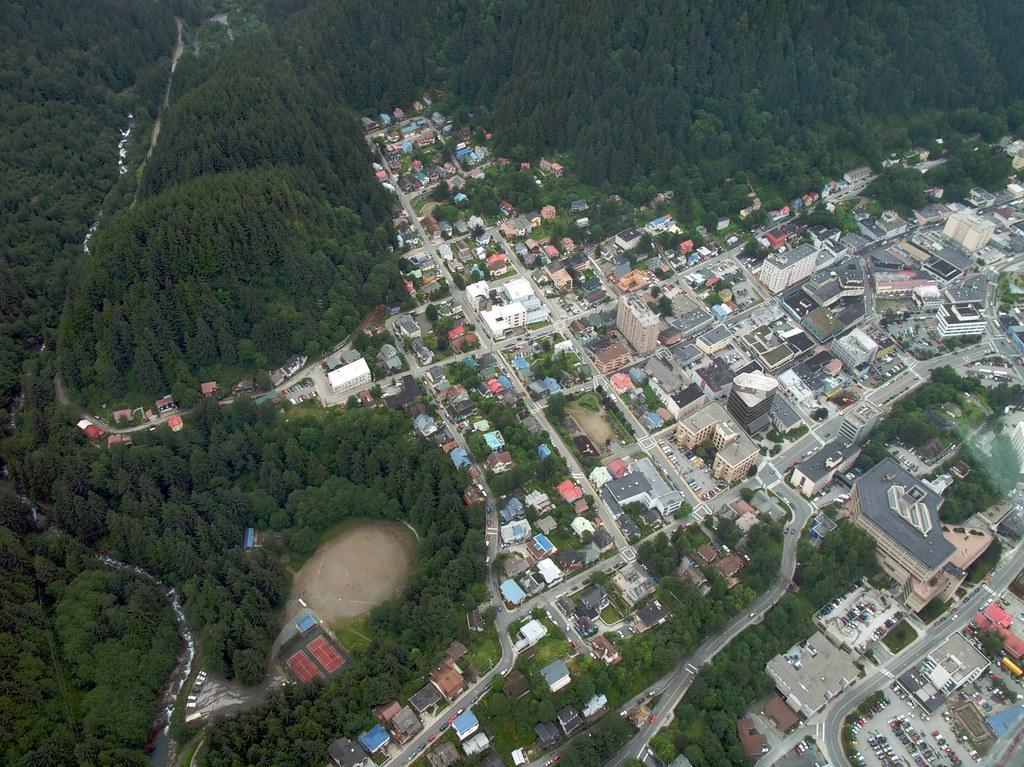 Juneau seen from above, tucked between the channel and the mountains