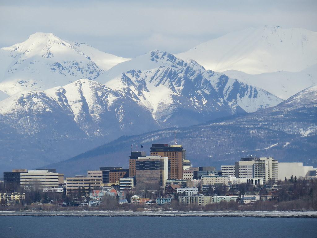 Downtown Anchorage seen from the water, with the Chugach range behind it